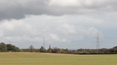 Rural green fields, big cloudy blue sky and overhead electricity pylons Stock-Footage 42506799