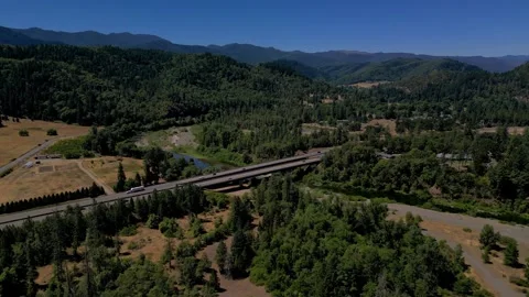 Rural highway with pine trees and mountains Vídeo Stock 294706362