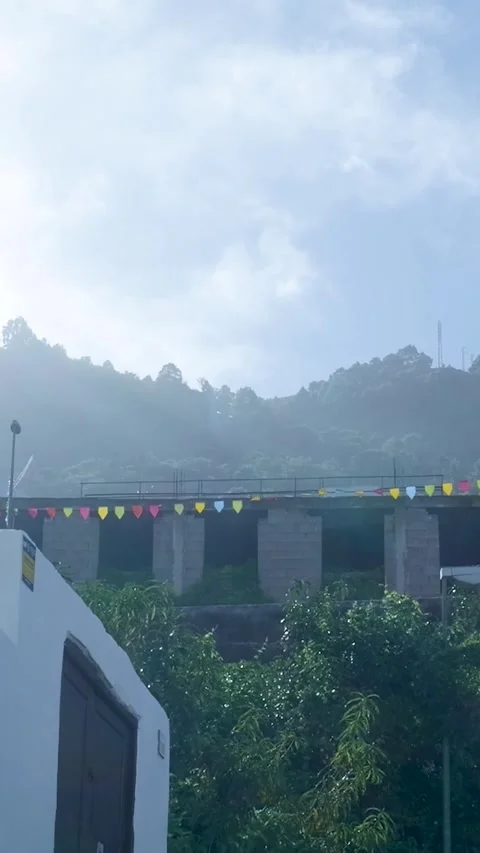 Rural hillside structure with festive pennant flags Vidéo 329865805