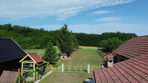 Rural House Surrounded by Forest and Nature – Aerial Drone View 動画素材 337023328