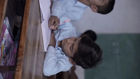 Rural Indian school students study in classroom. Elementary boys writing do.. Stock Footage 274334745