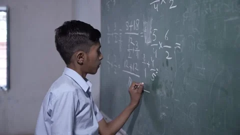 Rural indian student write solve math sum on chalkboard or blackboard in cl.. Stock Footage 273547377