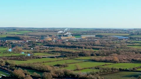 Rural industrial complex functioning amid green countryside fields. Stock Footage 329067724