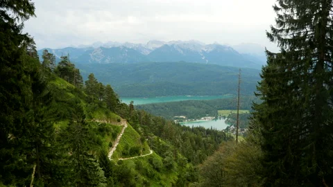 Rural lake landscape with mountain panorama in background and forest trees Stock Footage