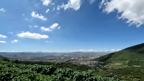 Rural landscape with blue sky, clouds and mountains in the background Stock Footage 287361271