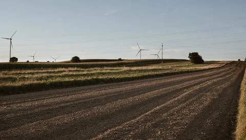 Rural landscape with empty fields and wind turbines Stock Photos