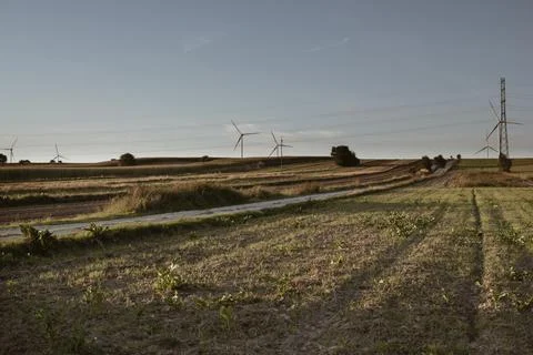 Rural landscape with empty fields and wind turbines Stock Photos