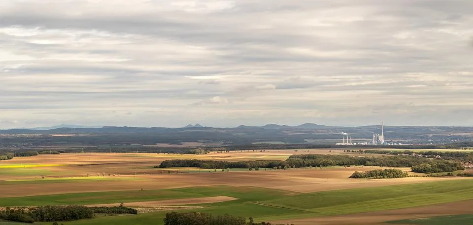 Rural landscape with fields, forests, buildings and a thermal power plant Stock Photos