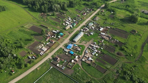 Rural landscape highlighting community development, verdant farmland spanning Stock Footage 318306567