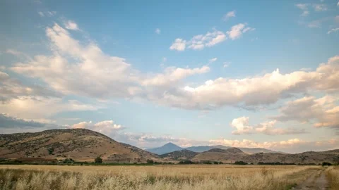 Rural landscape motion time lapse with fast moving clouds Stock Footage 242583572