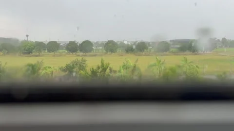 Rural landscape seen through a rain-covered window on a rainy day. Stock Footage 345043048