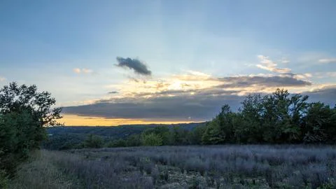 Rural Meadow At Sunset Beneath Dramatic Evening Clouds Stock Photos