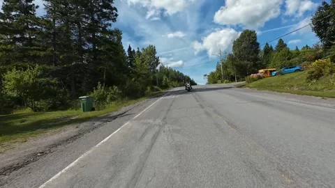 Rural Motorcycle Ride Along Paved Road at the Edge of a Quebec Village 스톡 동영상 345523322