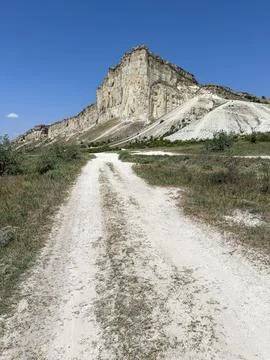 Rural mountain path under blue sky Stock Photos