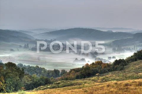 Rural mountain village in fog aerial view Stock Photos