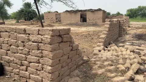 Rural Mud Brick Structure, Partially Destroyed Building in Arid Landscape Stock Footage 320354817