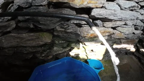 Rural Nepal, showcasing a basic stone toilet with a rudimentary water flushing 스톡 동영상 297194659