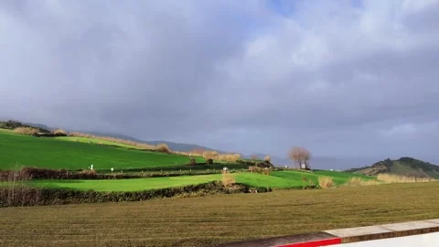 Rural road and green fields Sao Miguel Azores Portugal 스톡 동영상 331044459