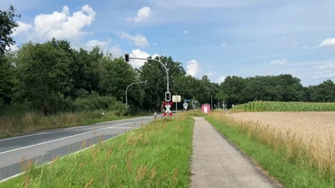 Rural Road Approaching Railway Level Crossing Between Fields Stock Footage 342604631
