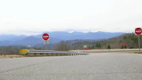 A rural road featuring multiple stop signs, with a scenic view of the Blue Ri Video stock 277559465