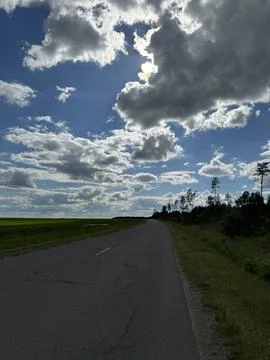 Rural Road Stretching Under Dramatic Cloudscape Stock Photos