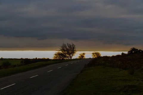 Rural road at sunset. Stock Photos