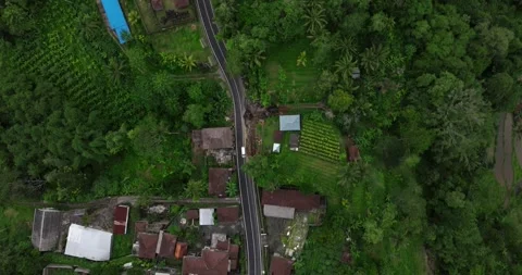 Rural road top view surrounded by lush greenery in Asia Stockbeeldmateriaal 276718633