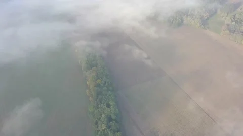 Rural scene. Flying through the clouds above mountain tops. Stock Footage 142224609