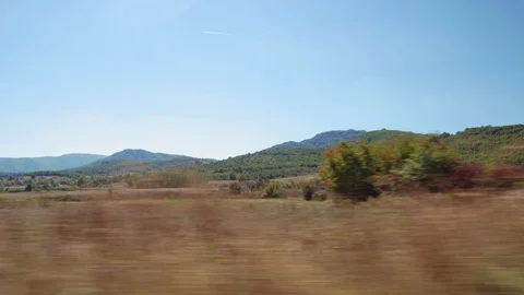 Rural scenery speeding car POV side window day sunny view motion blur. Stock Footage 117434457