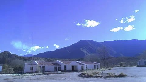 Rural School Building Beneath Dramatic Mountain Sky Stock Footage 331487424