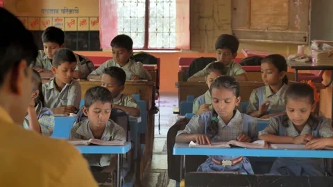 A Rural School Class Teacher taking primary children tuition in active classroom Stock Footage 172044199