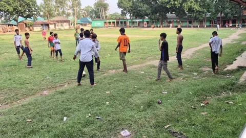 Rural School Students Gathering on Green Field for Football Match in Gazipur Stock Footage 336591564
