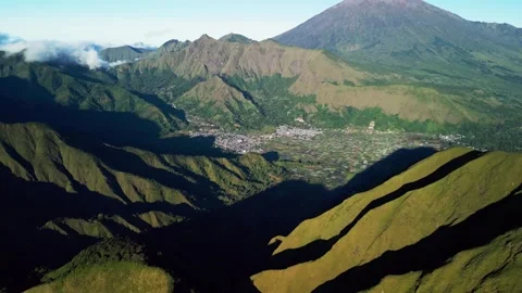 Rural Settlements Nestled Beneath Towering Mountains and Patchwork Agricultural Video stock 337138326