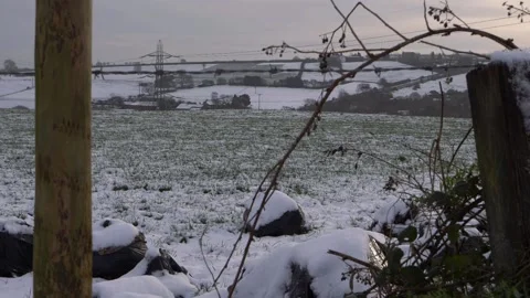 Rural snow scene through view of wooden fencing Stock Footage 149058218