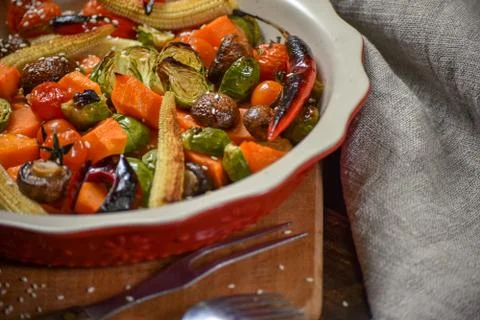 Rural still life of grilled vegetables and in a large ceramic plate and appli Stock Photos