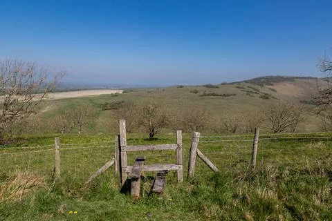 A rural Sussex view with a wooden stile in the foreground Stock Photos