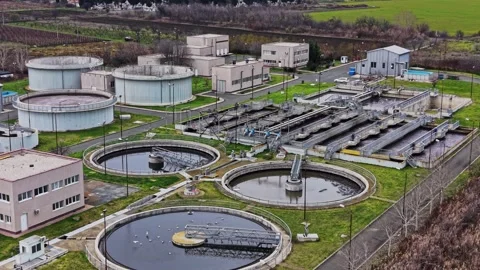 Rural water treatment facility with multiple tanks and buildings Stock Footage 332210770