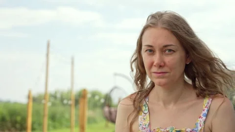 Rural Woman's Natural Charm Under a Soft Sky Stock Footage 338385331