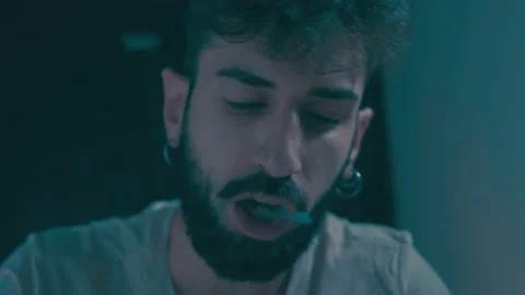 Rush gestures-high man first puts his finger then the ash into the cup of tea Stock Footage 197749371