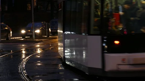 Rush hour, Rain wet road; lights; Tram rails and colorful water reflections i Stock Footage 101025586