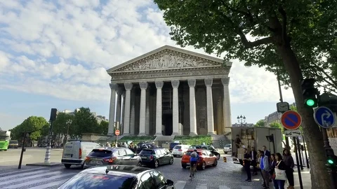 Rush hour traffic in front of La Madeleine church in Paris, France at dusk Stock Footage 99143381