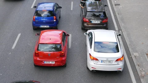Rush hour traffic. Seen from a bridge. Scooter and different cars Video stock 116597103