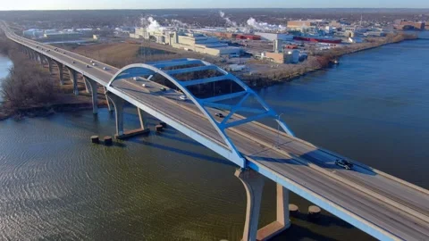 Rush hour traffic speeding across high bridge over river Stock Footage 181486796