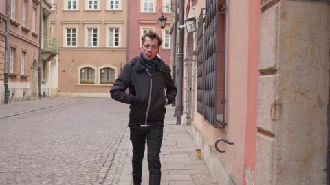 Rushing to an appointment, a man quickly checks the time on his phone Stock Footage 311192919