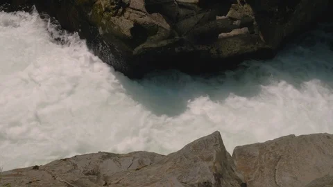 Rushing glacier river water in between canyon rocks from above Stock-Footage 107898775