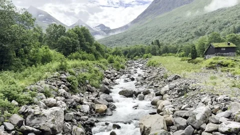 Rushing mountain river flowing through rocks with Stock Footage 338346057