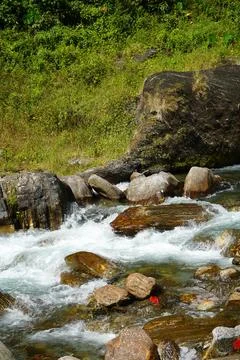 Rushing Mountain River Stream Flowing Over Colorful Rocks and Boulders Stock Photos