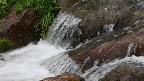 Rushing mountain stream flowing over rocks 库存影片 348631144