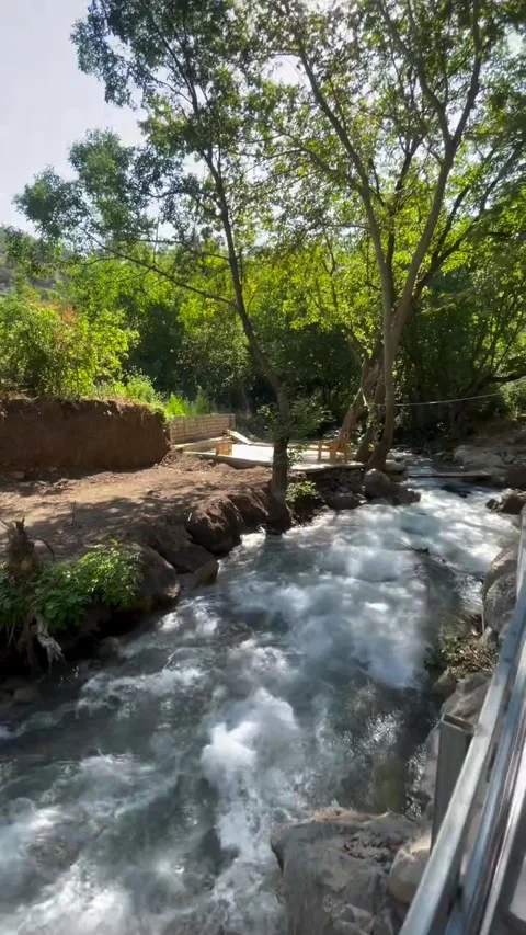 Rushing Mountain Stream by Wooden Platform and Trees Stock Footage 340871817
