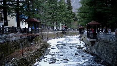 A rushing river cuts through a snowy landscape, creating a beautiful contrast be Stock Footage 303486269